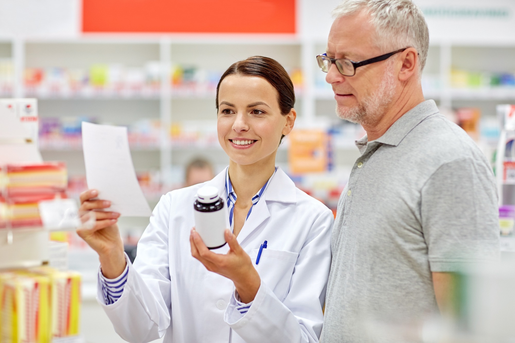 Pharmacist assisting a man at drugstore